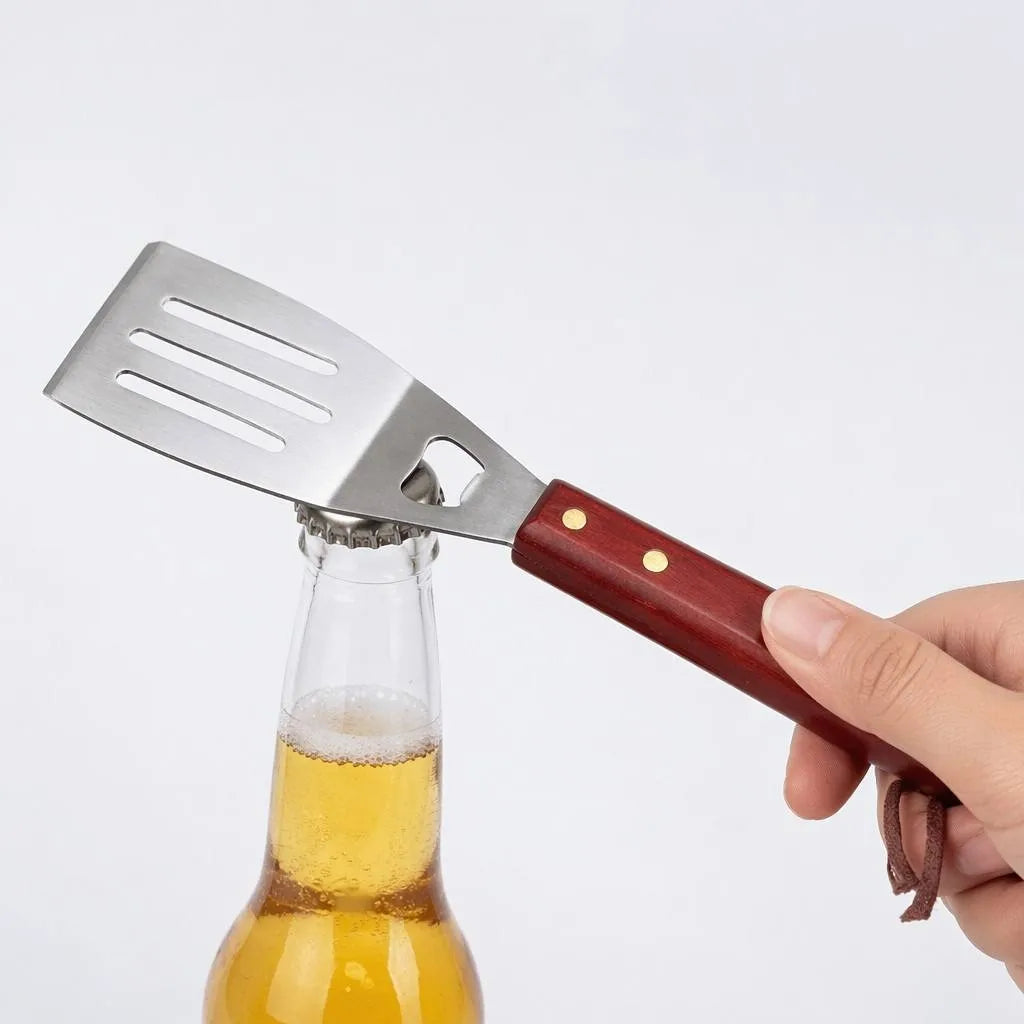 BBQ spatula with built-in bottle opener opening a beer